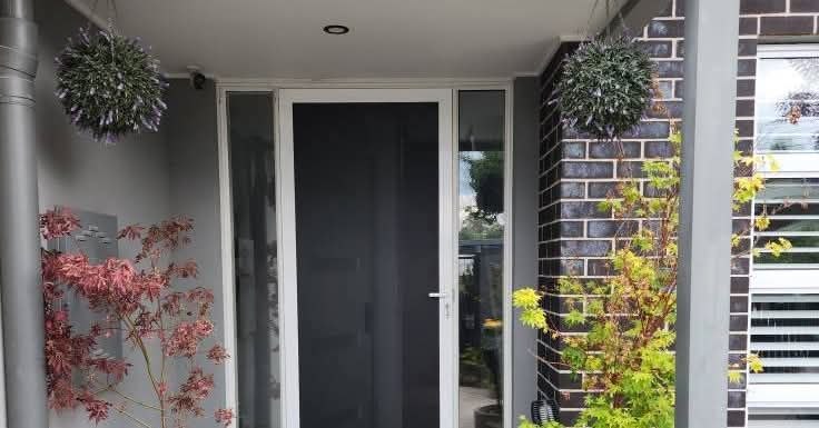 Security door installation at modern home, grey and black finish